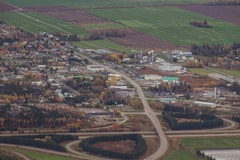 an aerial view of a small town with a road running through it