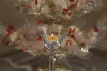 Elegant communion candle glowing softly beside a simple lace cloth