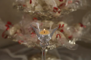Elegant packaging of a luxury candle with soft glowing light in the background.
