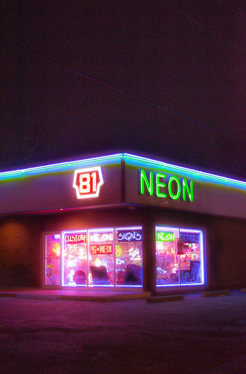 a neon lit neon store front at night