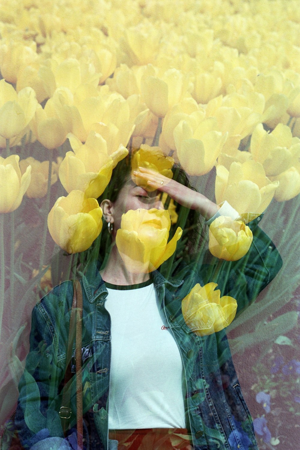 a woman standing in a field of yellow flowers