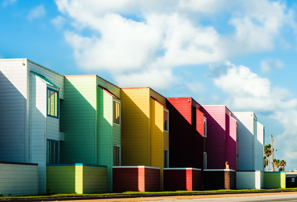 a row of multicolored houses on a street