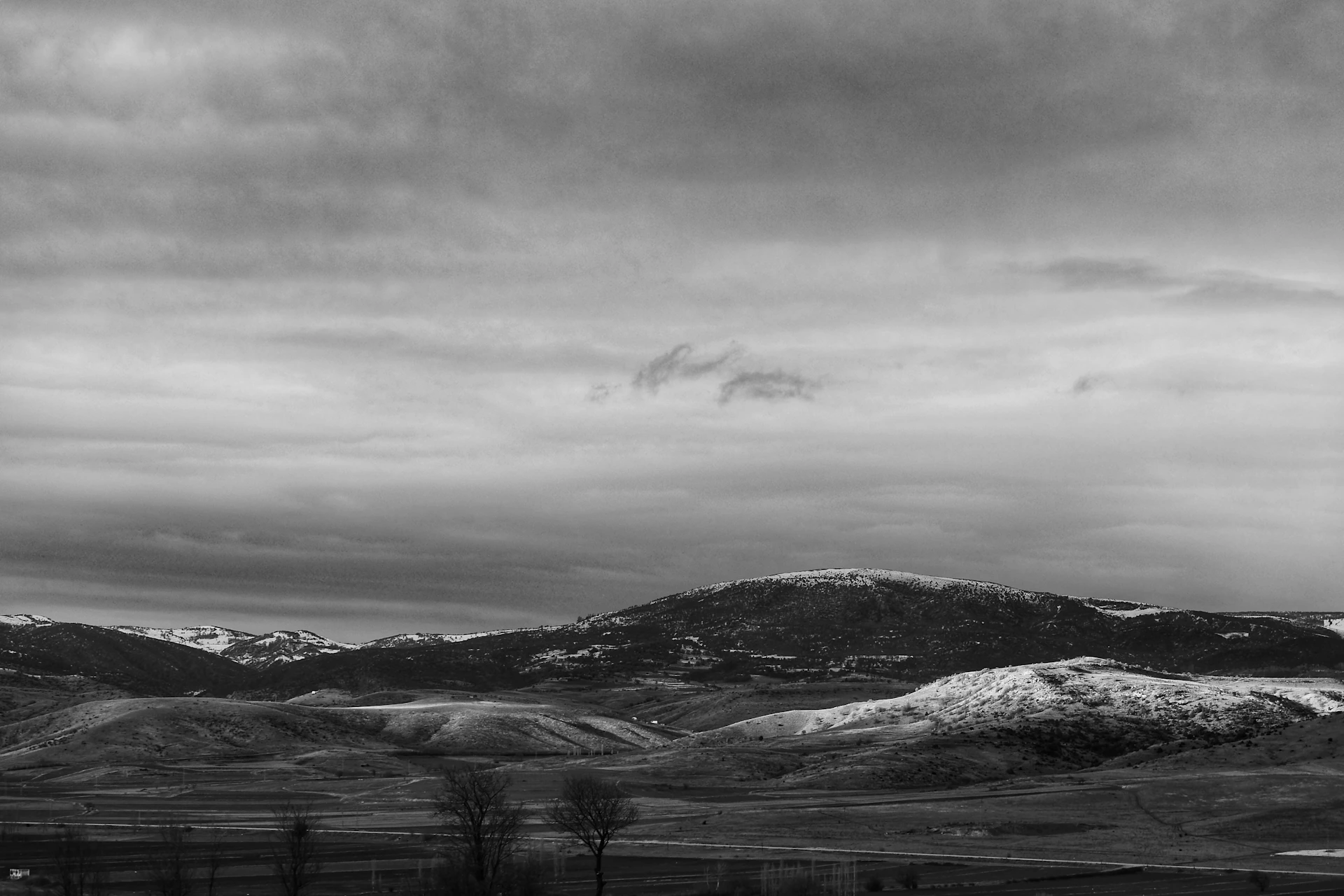 a black and white photo of a mountain range