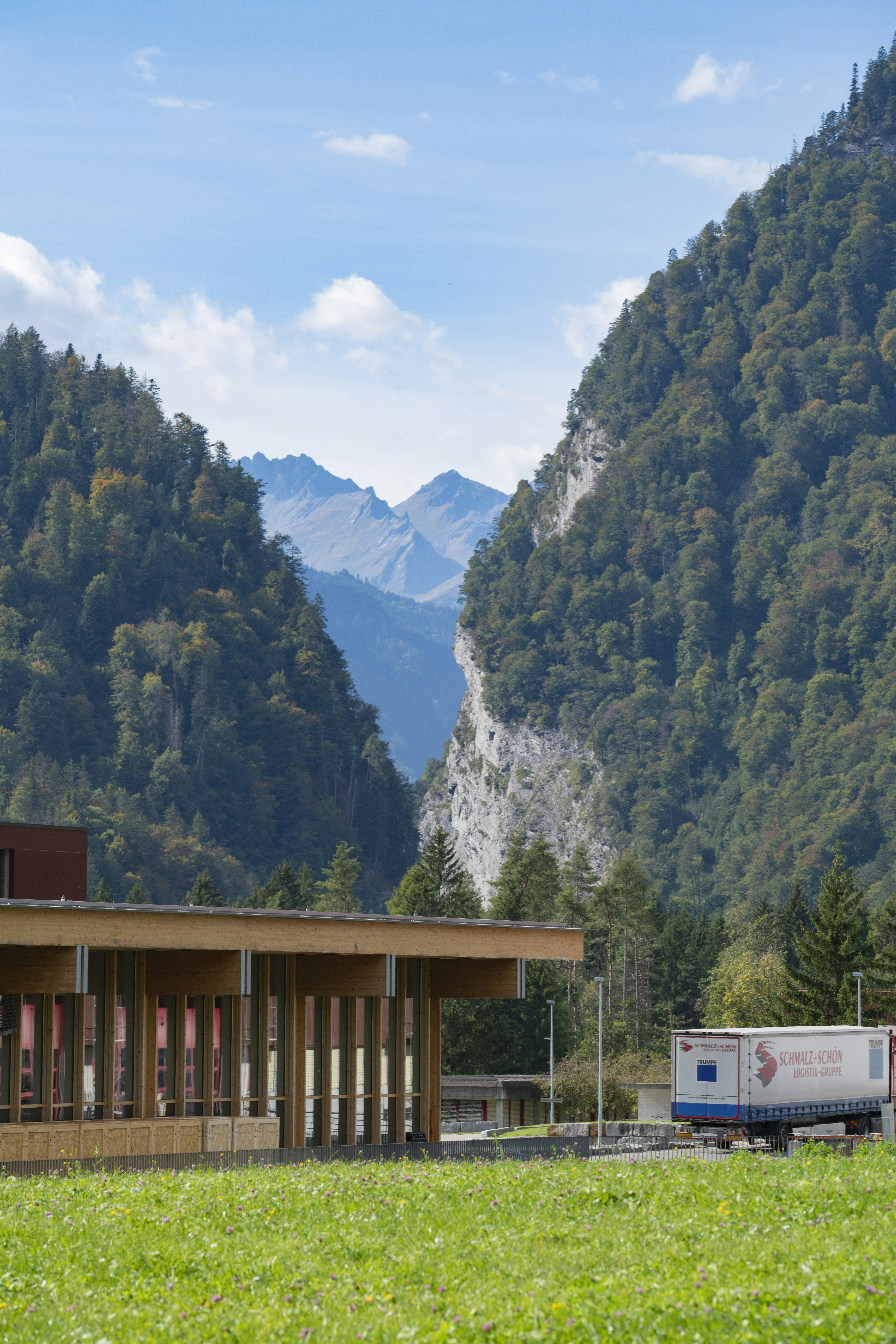 Delivery truck on a Pacific Northwest highway with mountains in the background
