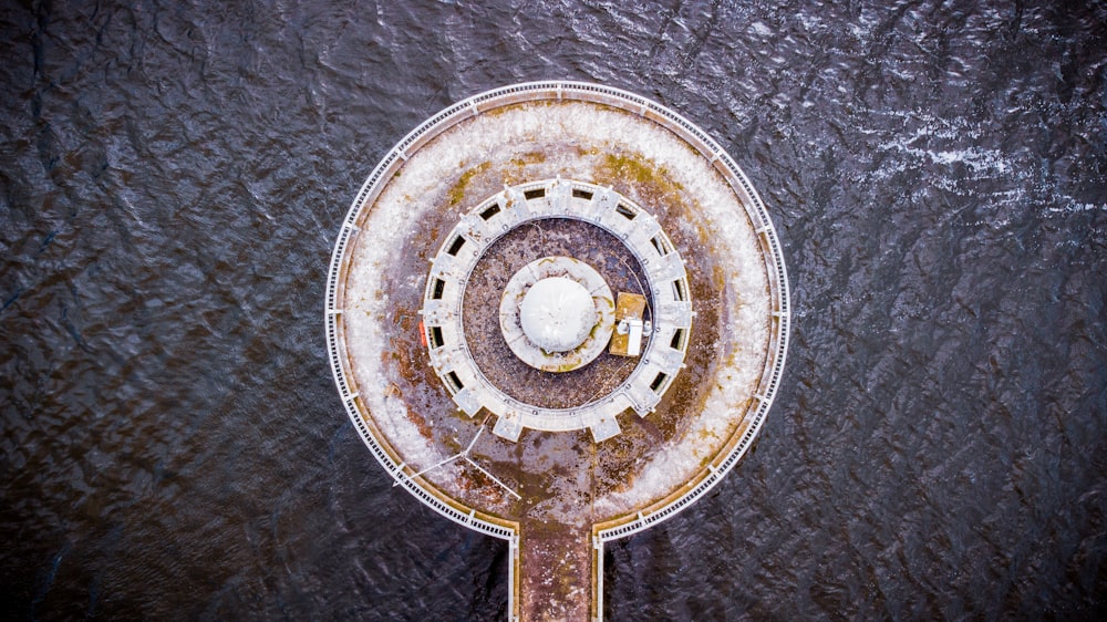 an aerial view of a circular structure in the water
