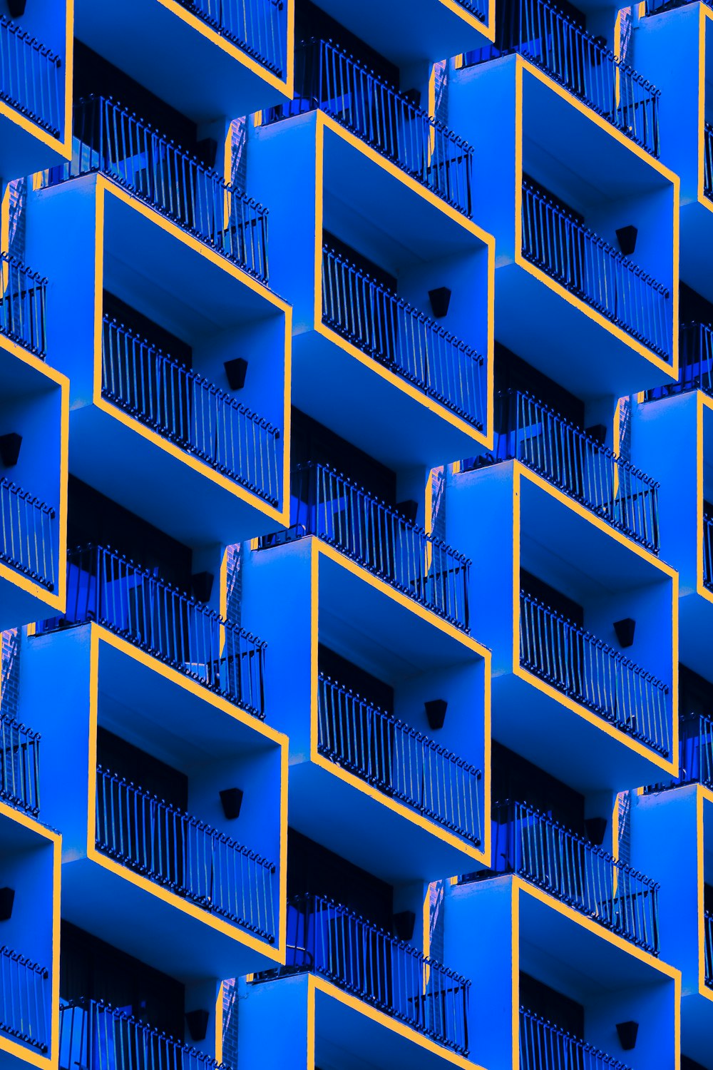 a blue building with balconies and balconies on the balconies