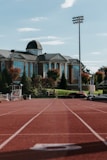 a tennis court with a building in the background