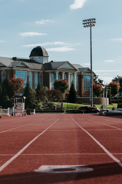 a tennis court with a building in the background