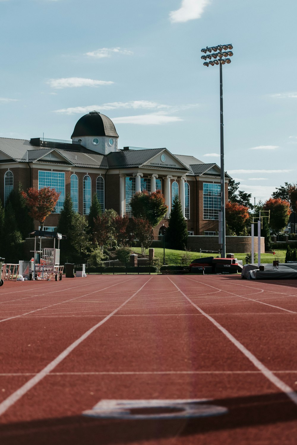 a tennis court with a building in the background