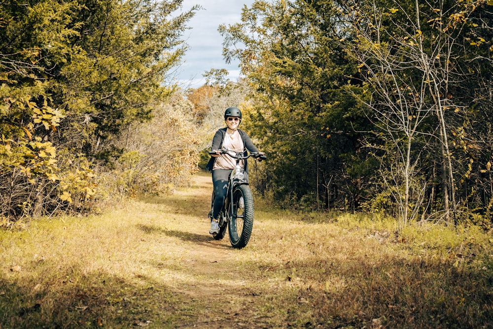 a person riding a bike down a dirt road