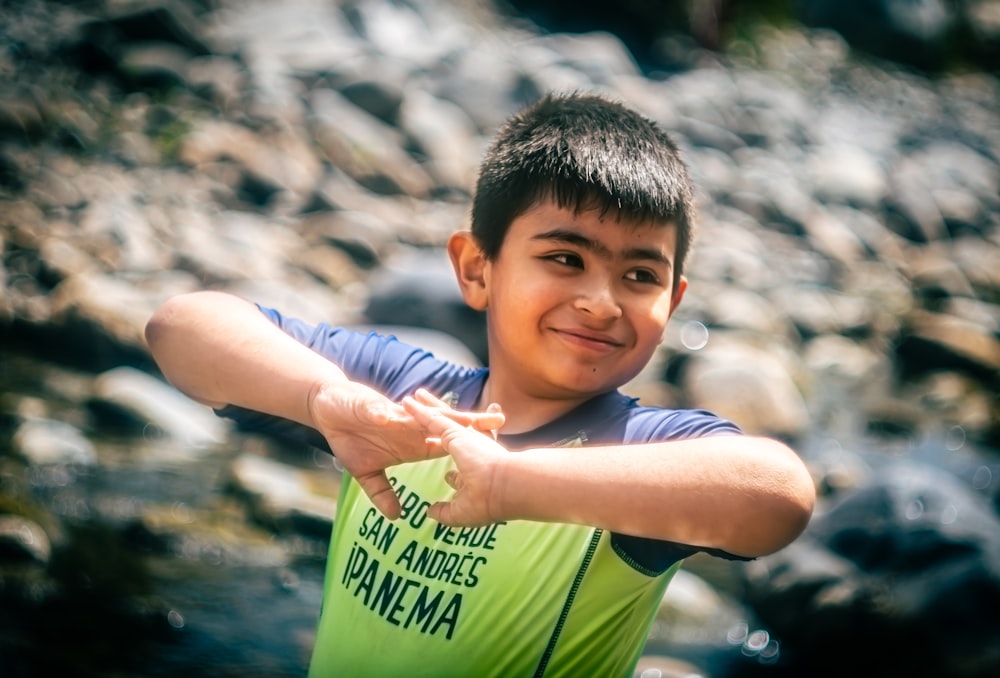 a young boy is pointing his finger at the camera