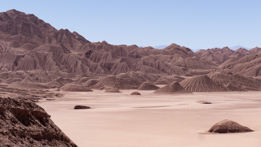 a desert landscape with mountains in the background