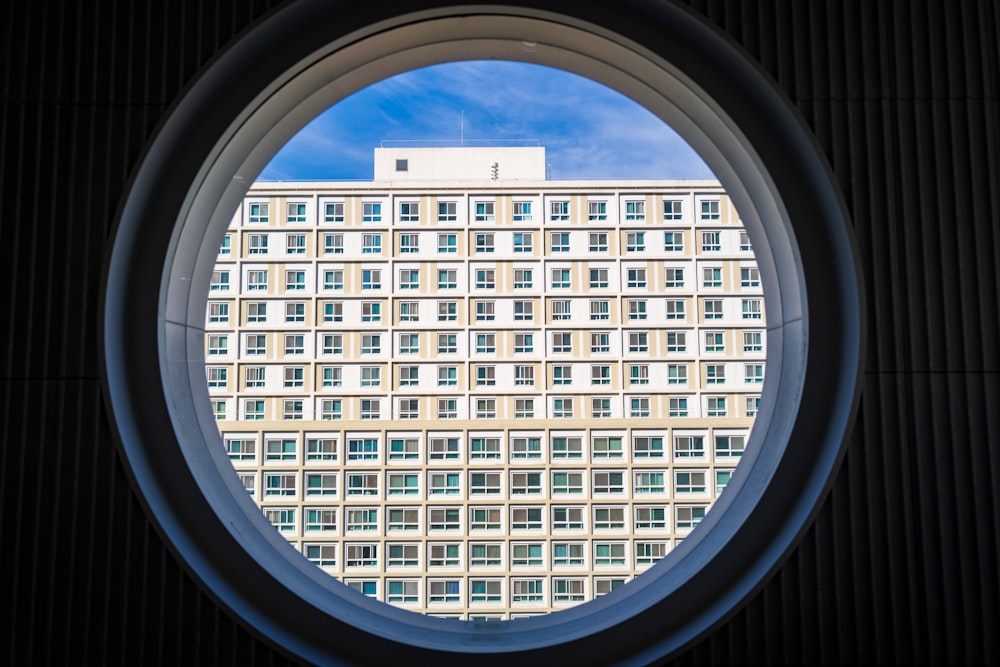 a building seen through a round window in a building
