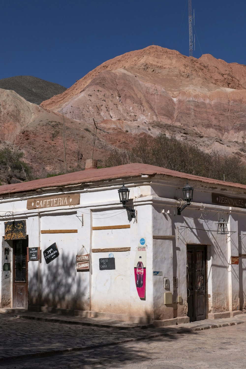 a white building with a mountain in the background