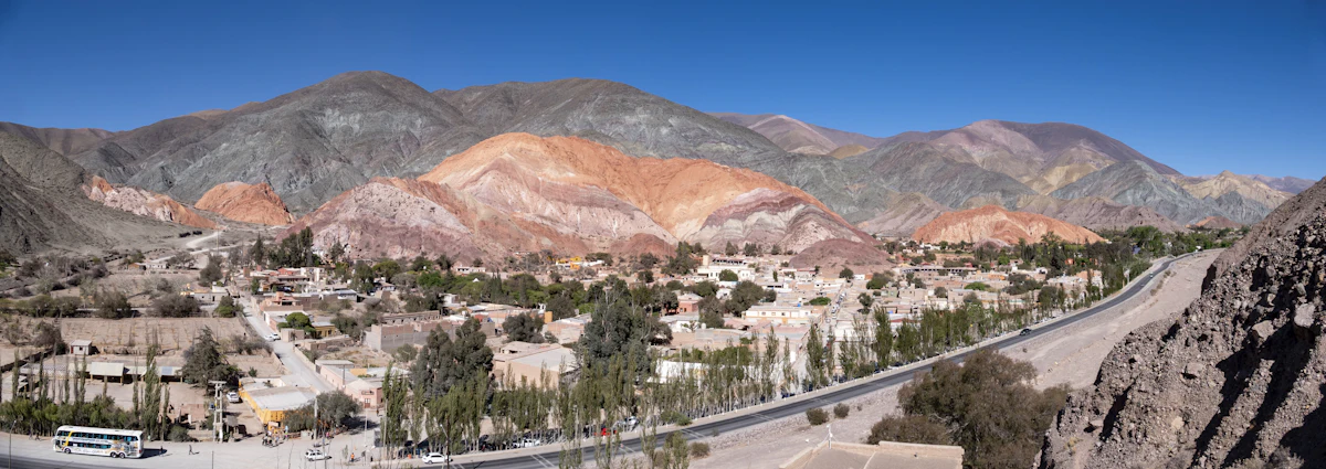 Purmamarca from above, its houses and poplars beneath the striped hills