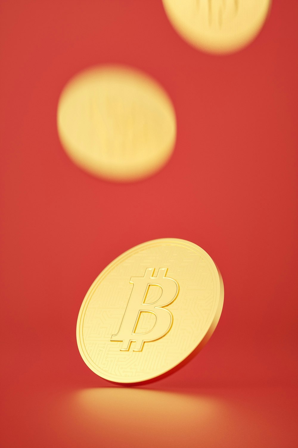 a close up of a bit coin on a red background