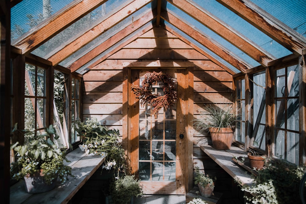 a wooden building with lots of plants inside of it