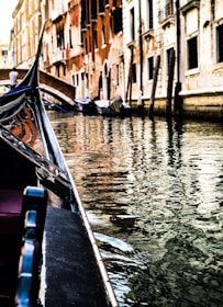 A serene gondola gliding through Venice’s narrow canals at twilight, lights reflecting on the water.