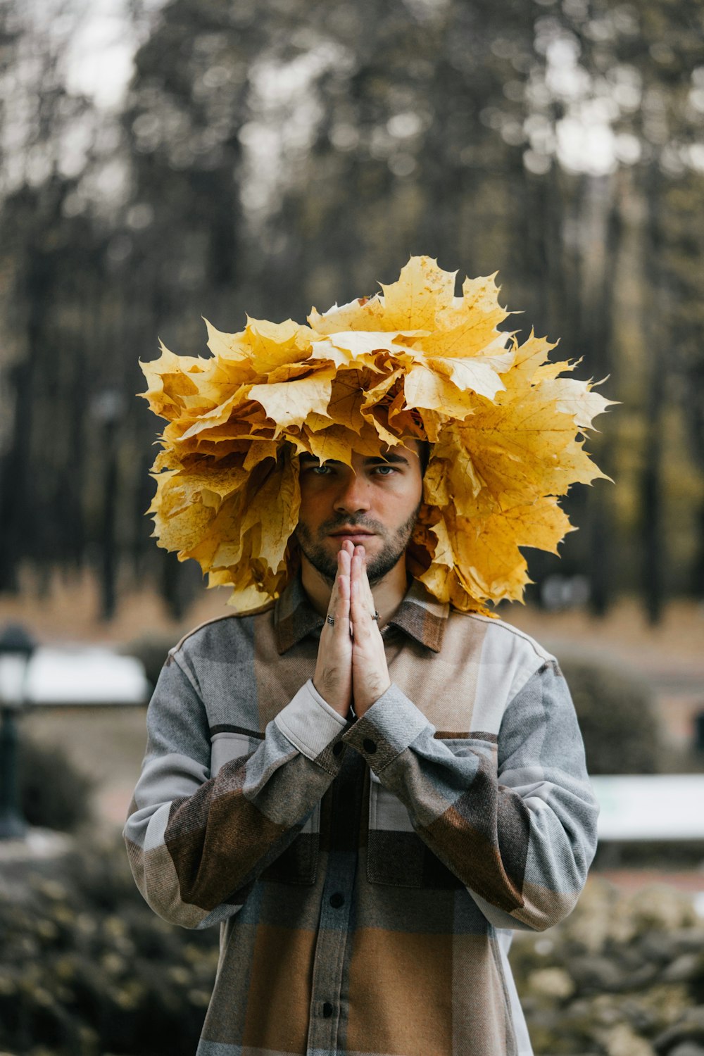 a man with a bunch of leaves on his head