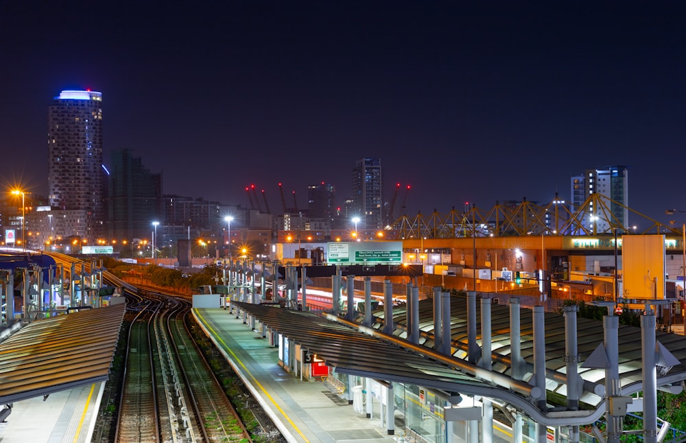 a train station at night with a train on the tracks