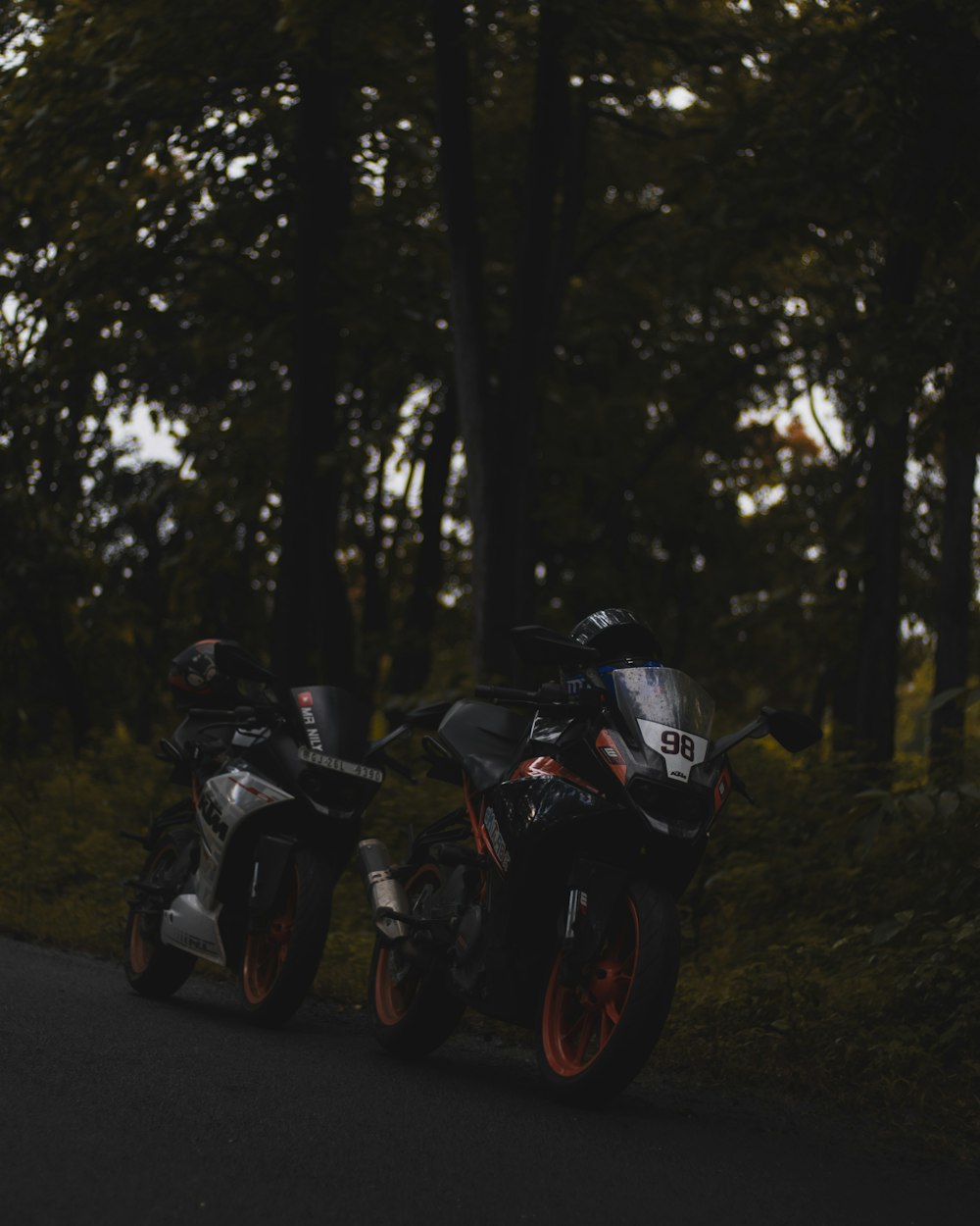 two motorcycles parked on the side of the road