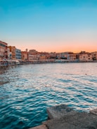 a body of water with buildings in the background