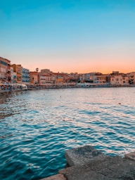 a body of water with buildings in the background