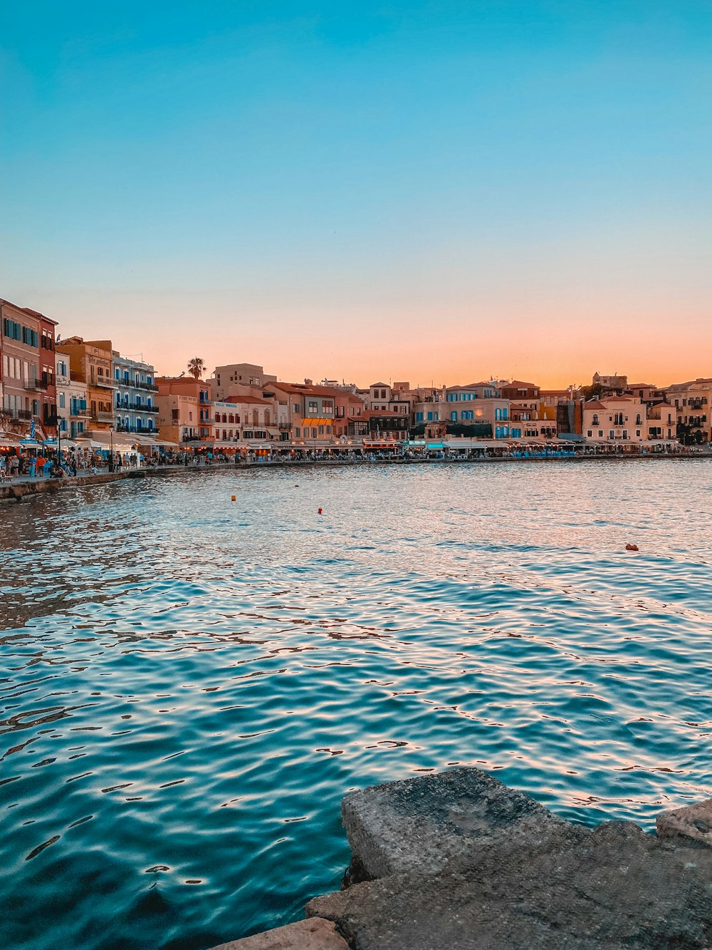 a body of water with buildings in the background