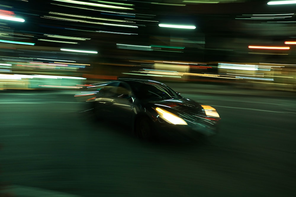 a car driving down a street at night