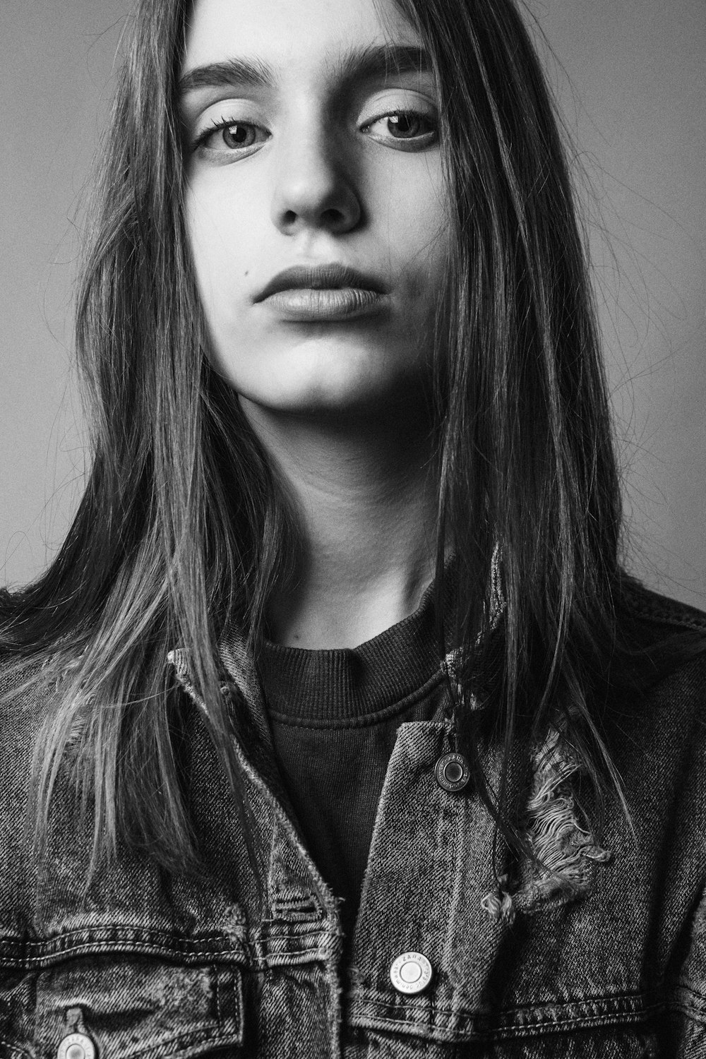 a black and white photo of a woman with long hair