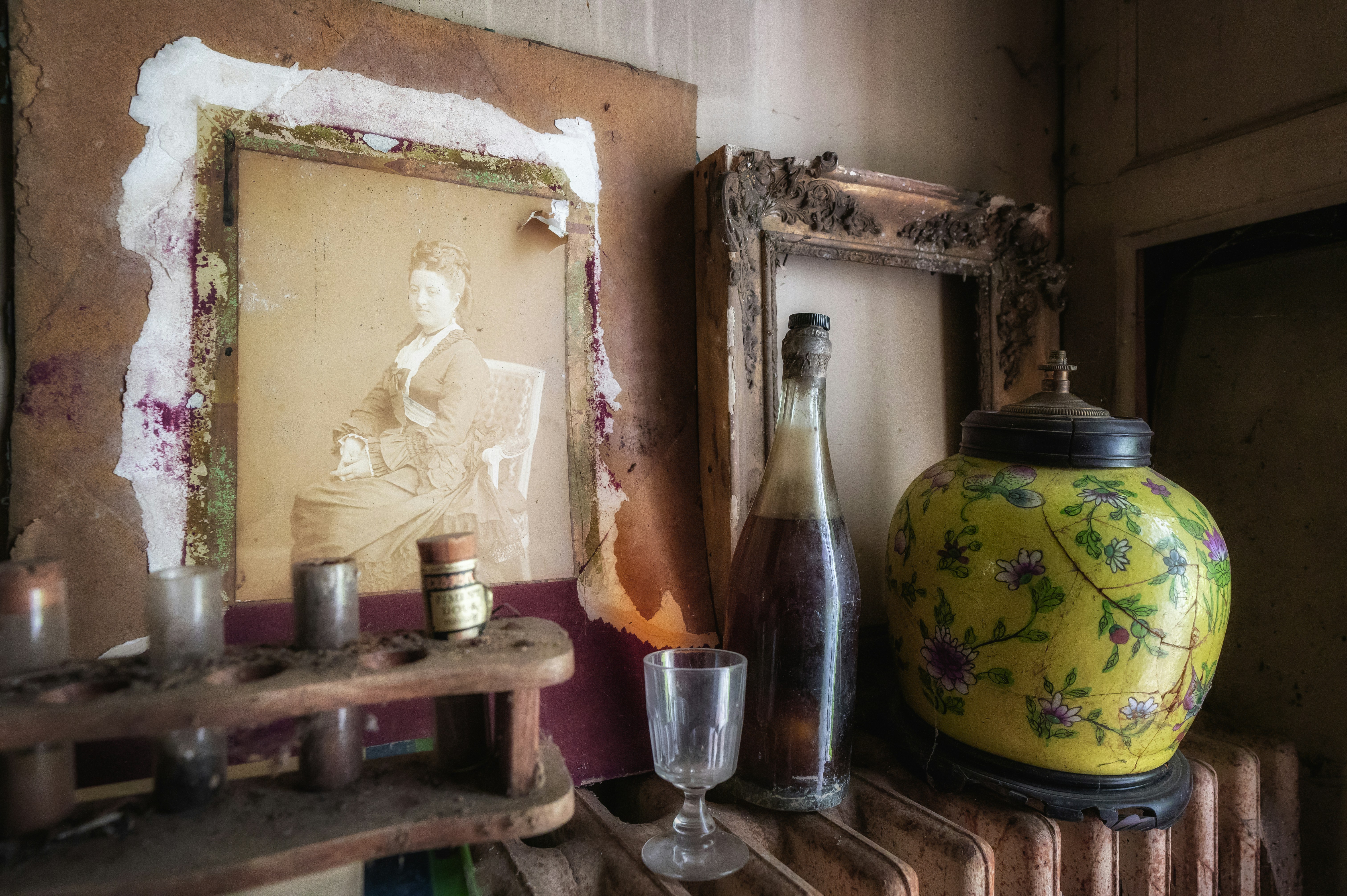 a yellow vase sitting on top of a wooden shelf