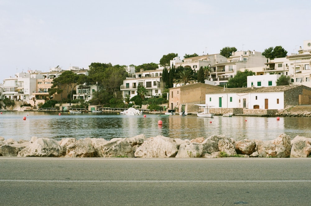 a body of water with houses in the background