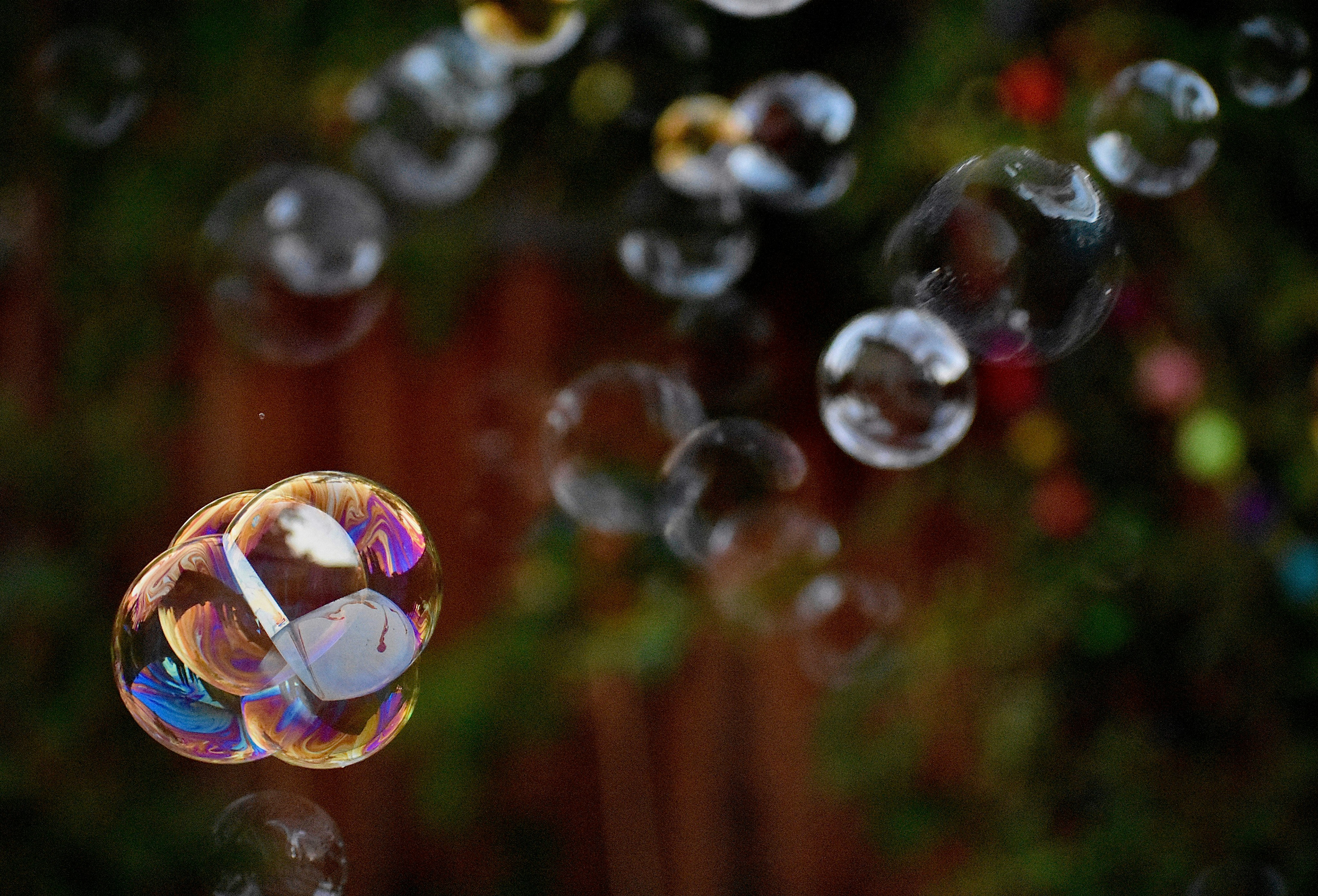 Close up reflective bubbles floating in the air during daytime  