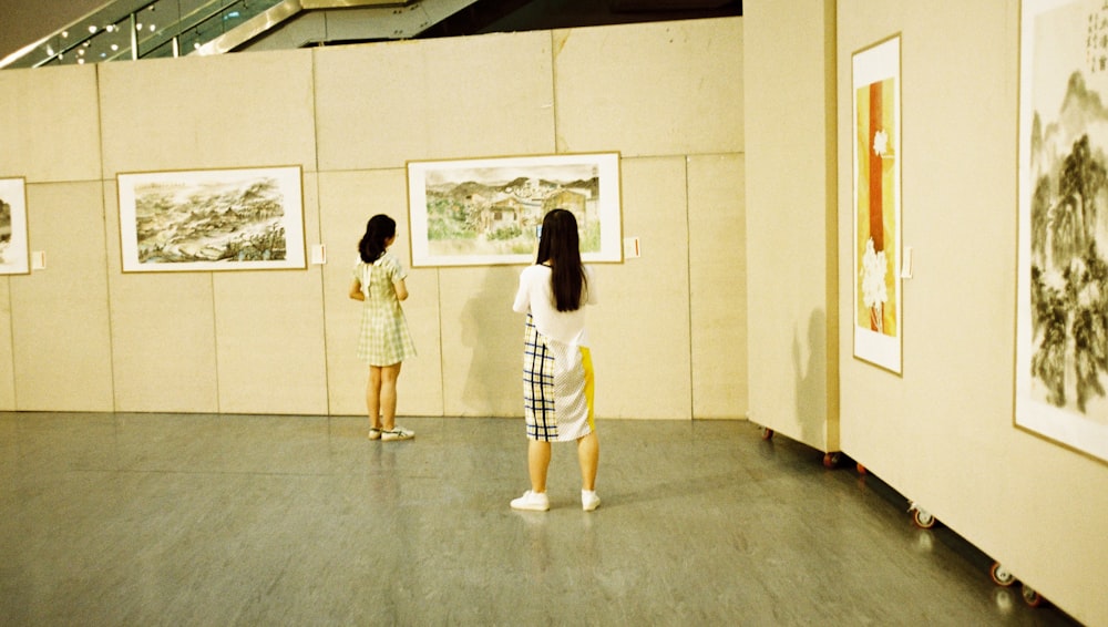 a couple of women standing next to each other in a room