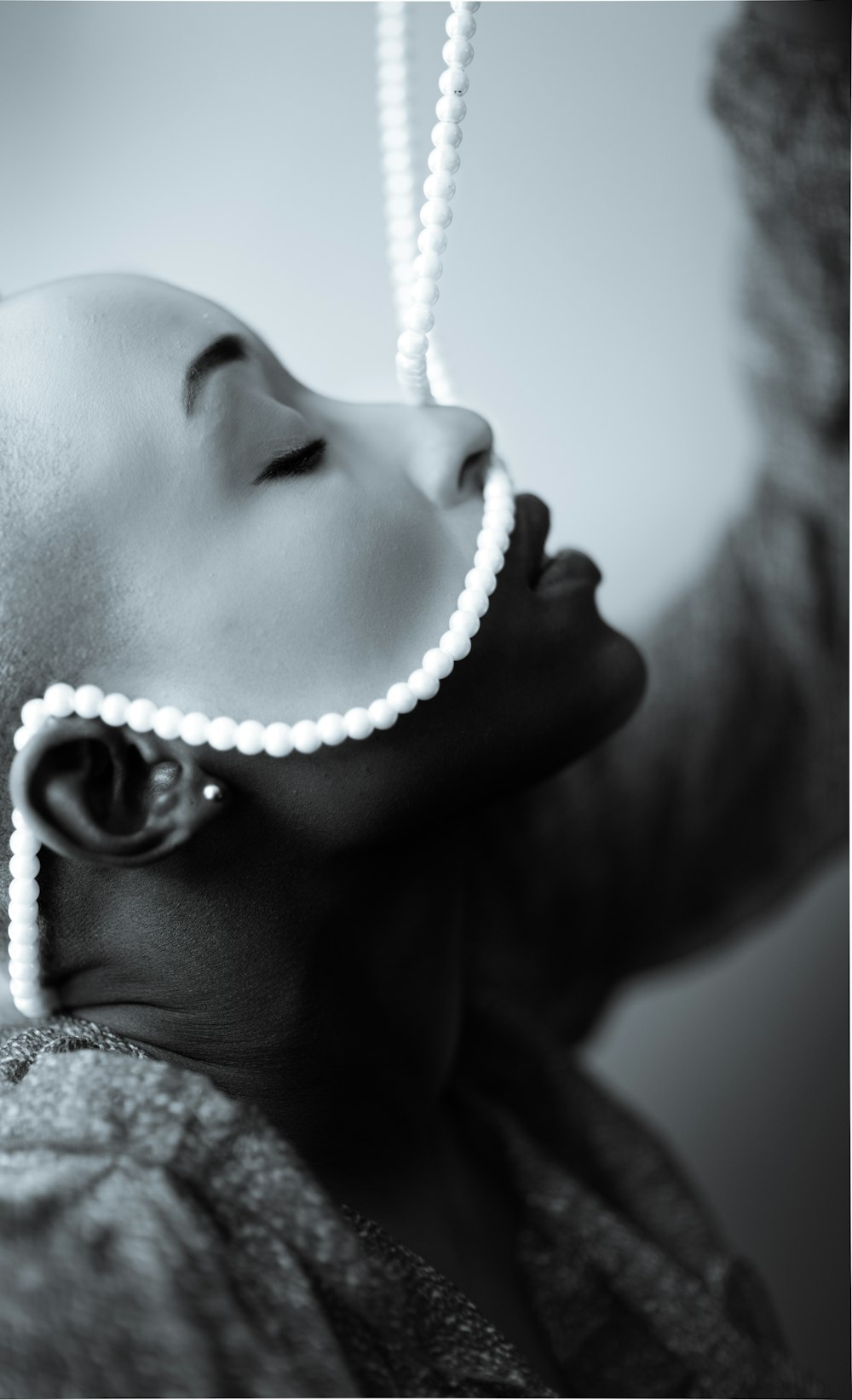 a woman with a pearl necklace on her head