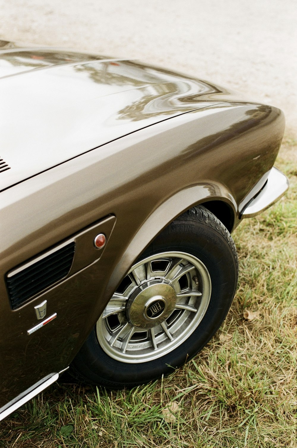 a close up of a car parked in the grass