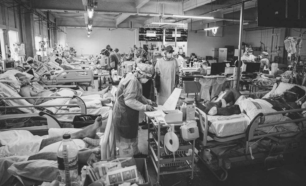 a black and white photo of people in a hospital