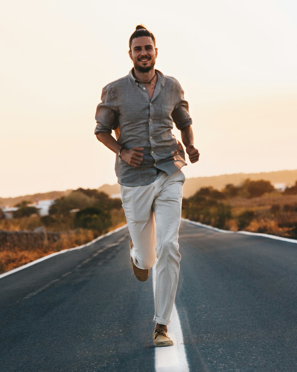 a man running down the middle of a road