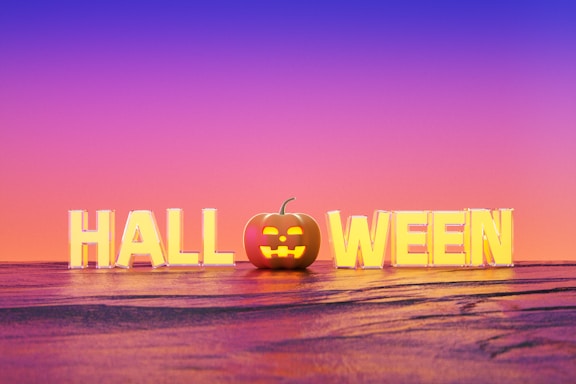 Large block letters spell out 'HALLOWEEN' with a pumpkin in place of the 'O'. The background features a gradient sky transitioning from purple to orange.