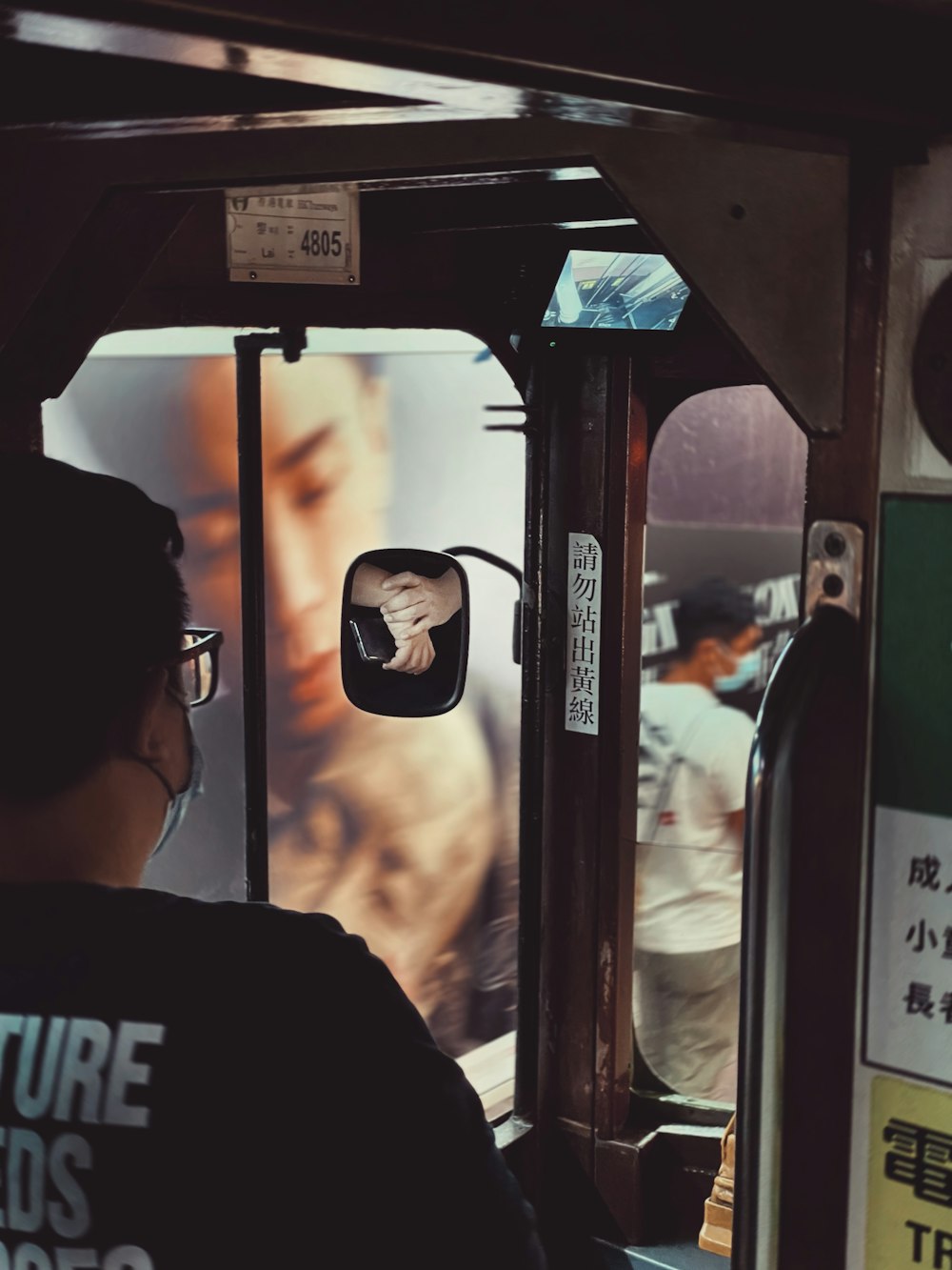 a man wearing a face mask riding a bus