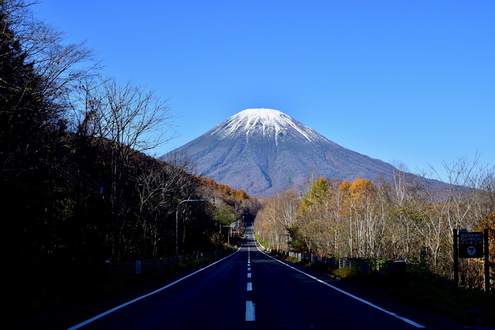 a road with a mountain in the background