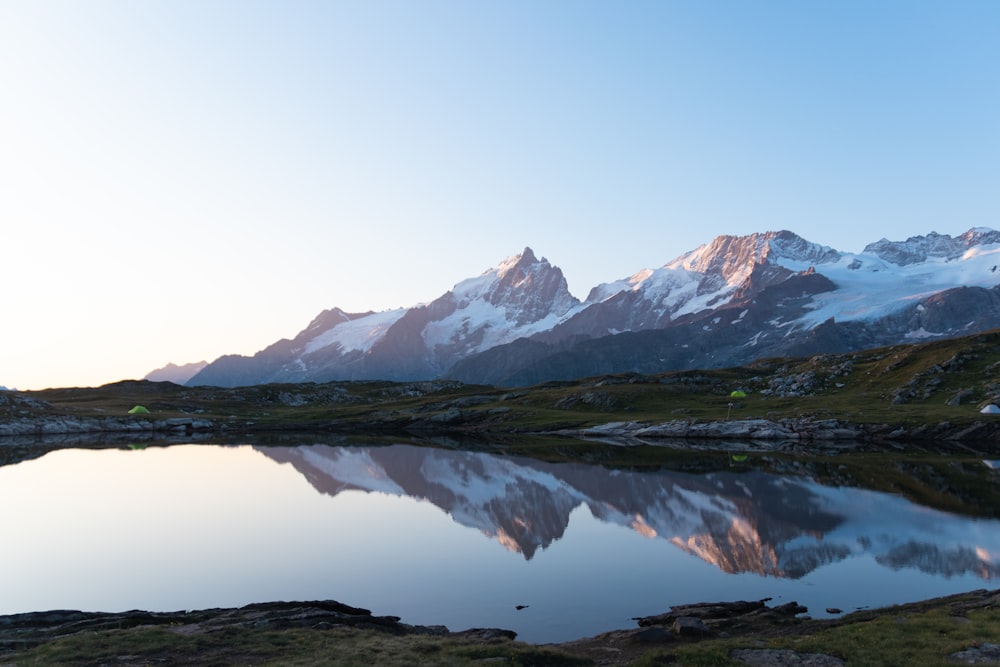 a mountain range with a lake in the foreground