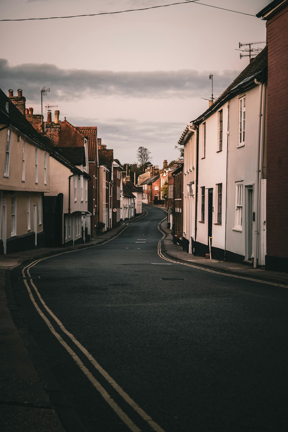 an empty street with houses on both sides