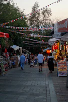 A lively market scene in Saint-Priest with colorful stalls and people browsing local goods.