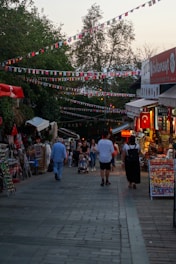 A lively outdoor market in Lubbock with colorful stalls and happy families.