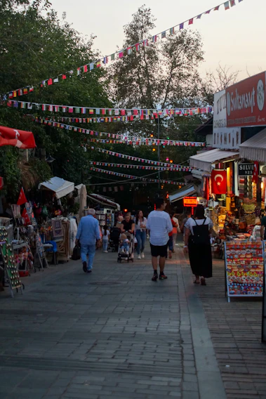 Colorful market stalls bustling with families shopping in a friendly neighborhood setting