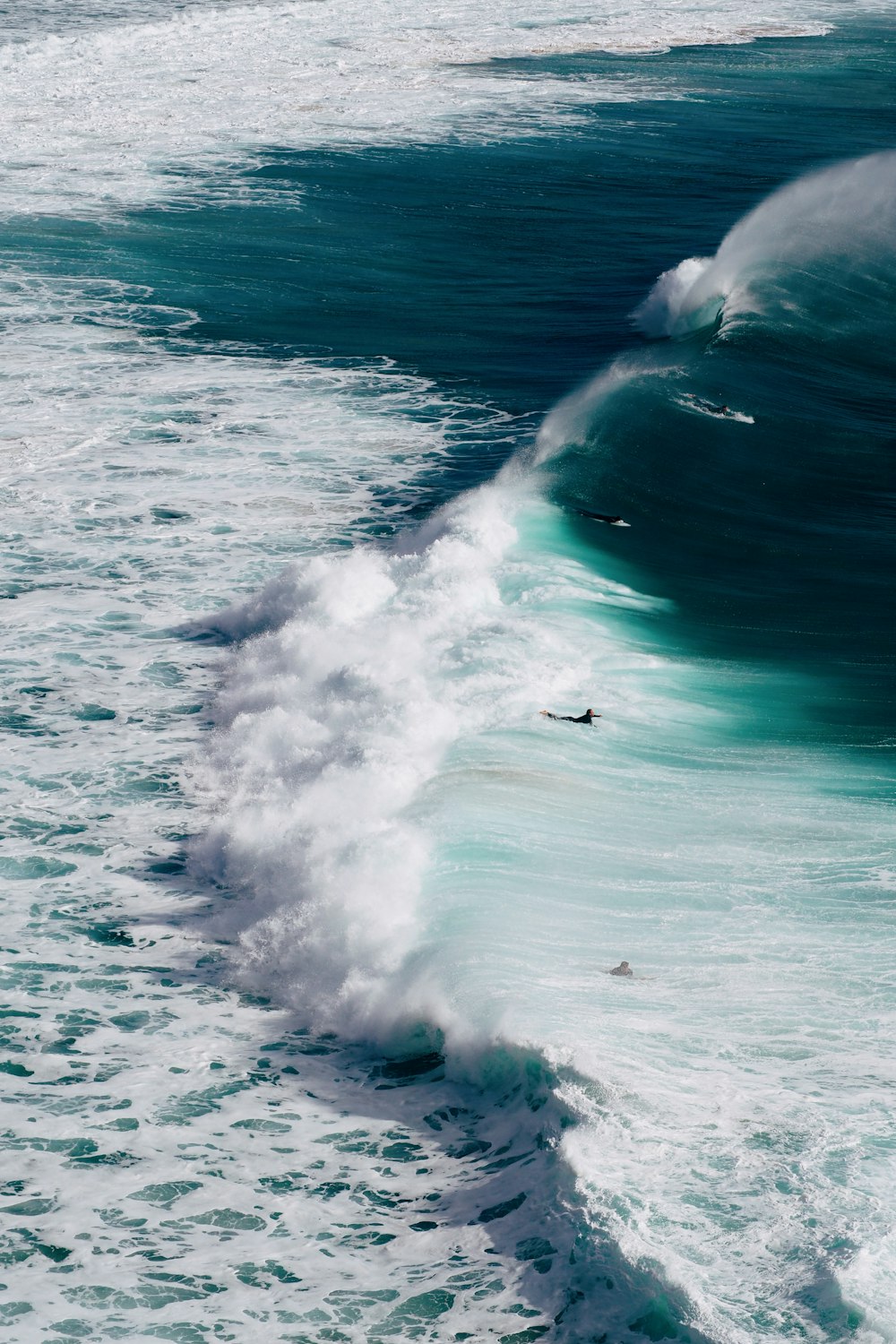 a person riding a wave on top of a surfboard