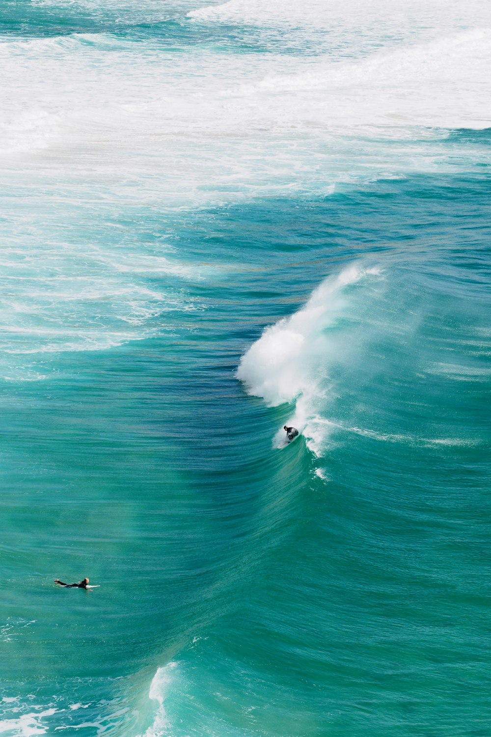 a man riding a wave on top of a surfboard