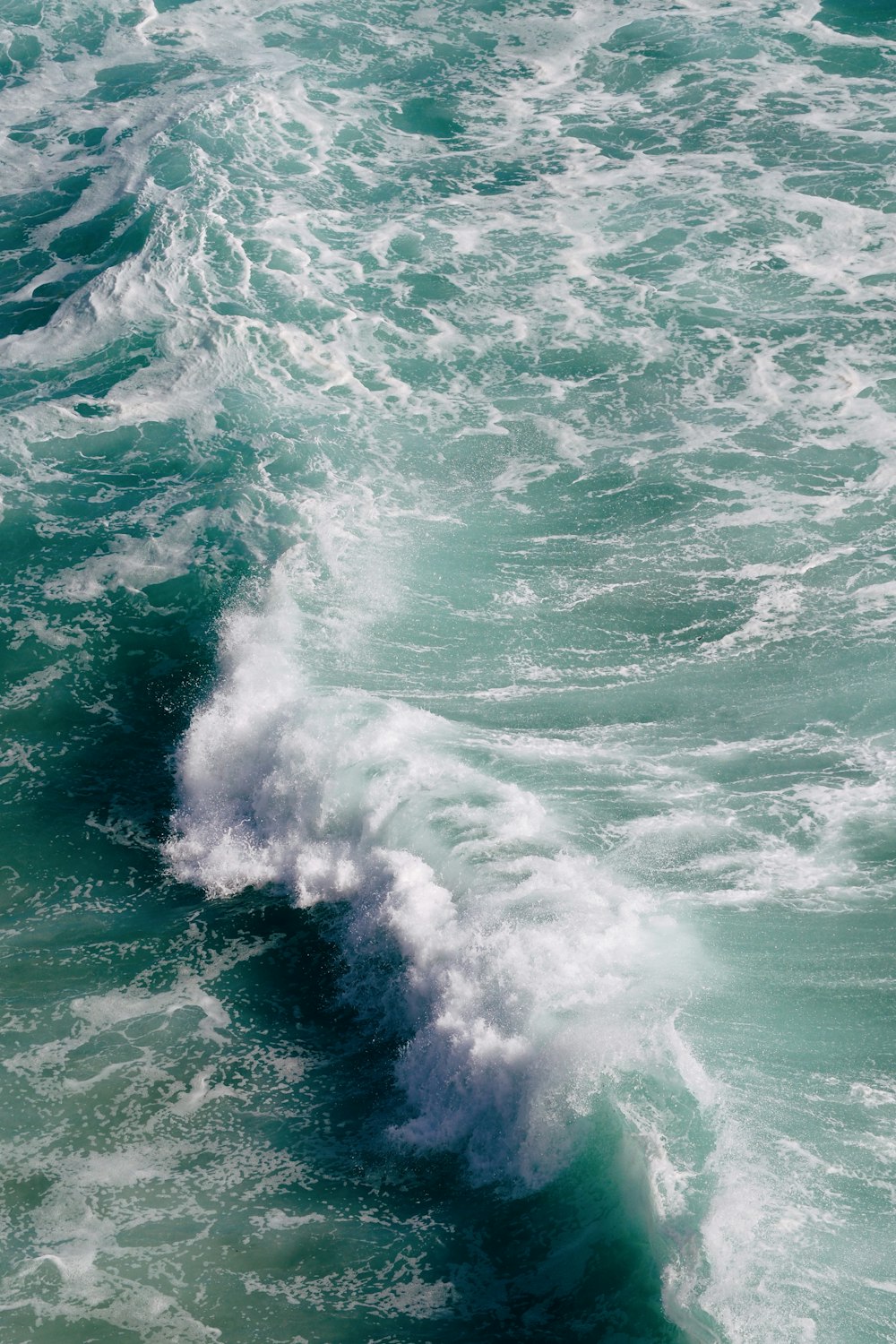 a person riding a surfboard on a wave in the ocean