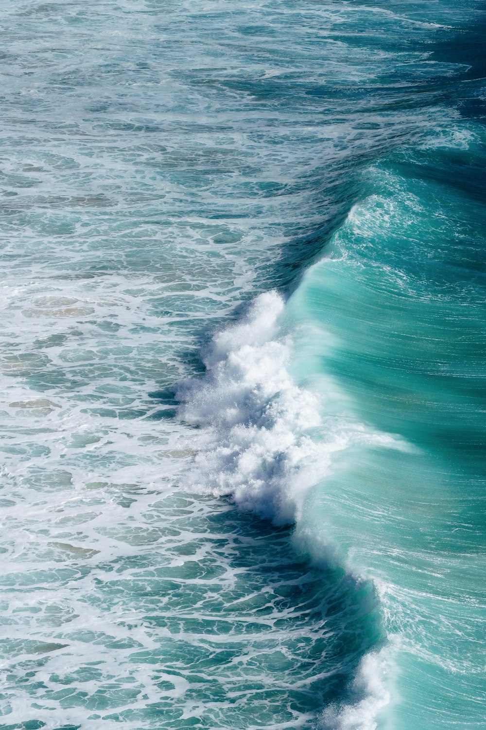 a person riding a surfboard on a wave in the ocean